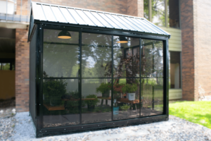 Fastpaks Verde Micro room being used as a greenhouse with numerous, different colored plants with closed doors